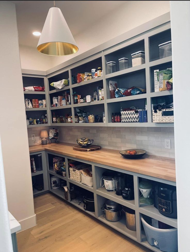 a kitchen with lots of shelves filled with food