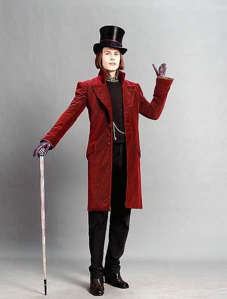 a woman in a red coat and top hat holding a cane with her hands up