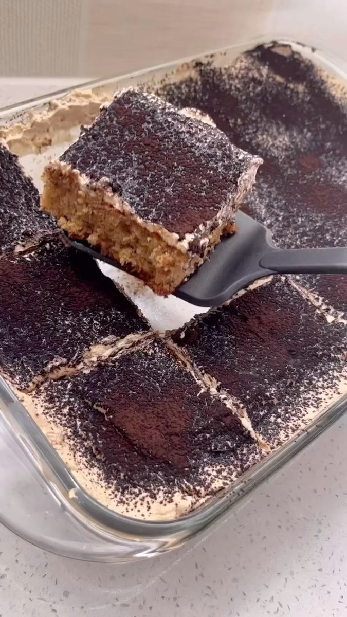 there is a dessert in the glass dish with a spoon stuck into it and ready to be eaten