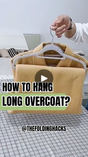 a man is holding a bag with the words how to hang long overcoat?