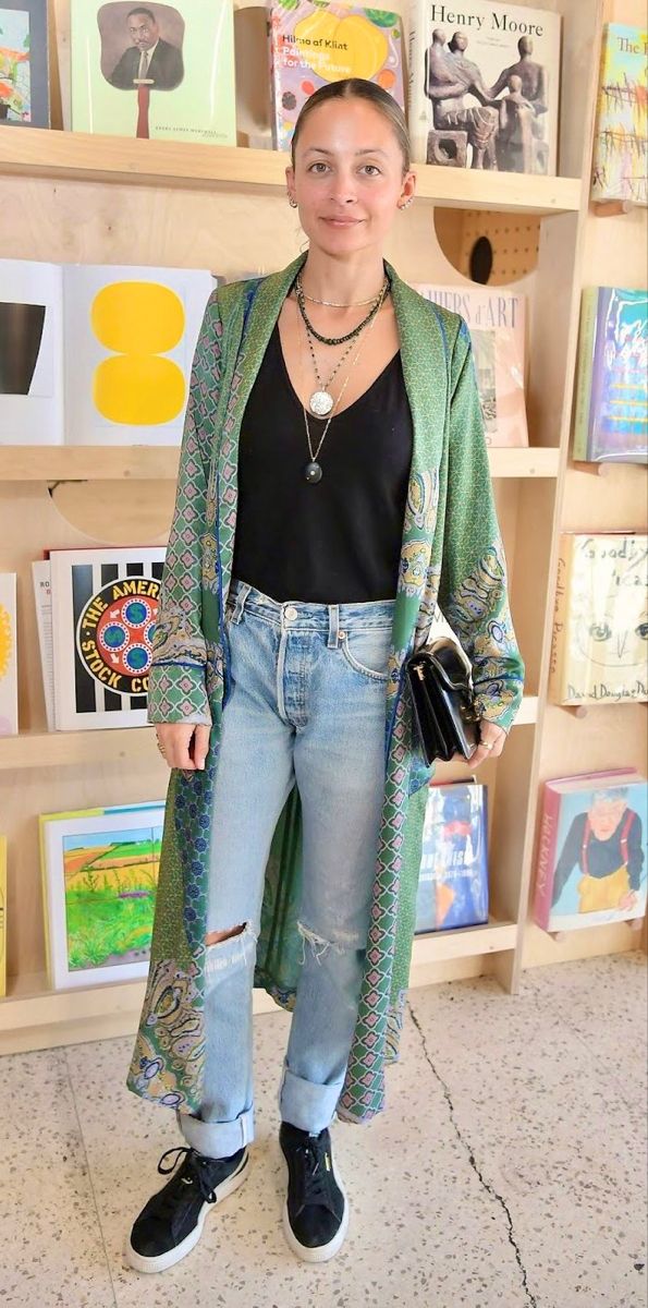 a woman standing in front of a book shelf