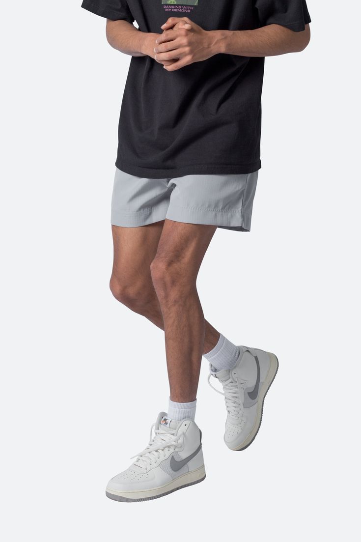 the Summer Shorts are constructed with a polyester fabric in a relaxed fit. The shorts feature an elasticized waist, welt pocket, and finished with a contrasting drawcord with a metal aglets. details elasticized self waist with drawstring relaxed fit 100% polyester model is 5’11, 140 lbs and wears a size medium Functional Elastic Waistband Shorts For Summer, Athleisure Gray Shorts With Elastic Waistband, Functional Relaxed Fit Shorts With Elastic Waistband, Functional Shorts With Elastic Waistband And Relaxed Fit, Functional Relaxed Fit Shorts With Drawstring, Gray Nylon Shorts, Gray Athleisure Bottoms For Summer, Functional Summer Bottoms With Elastic Waistband, Gray Relaxed Fit Athletic Shorts