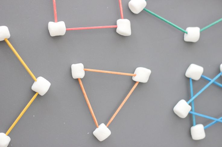 marshmallows and toothpicks are arranged on a gray surface