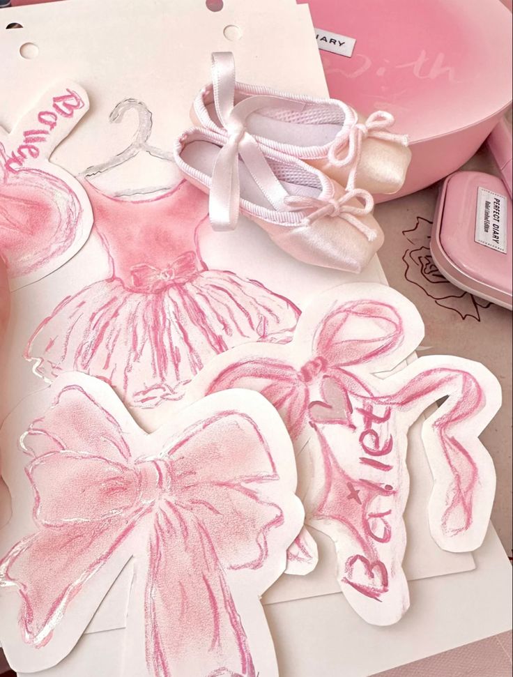 some pink and white items are laying on a table with other things to be used for crafts