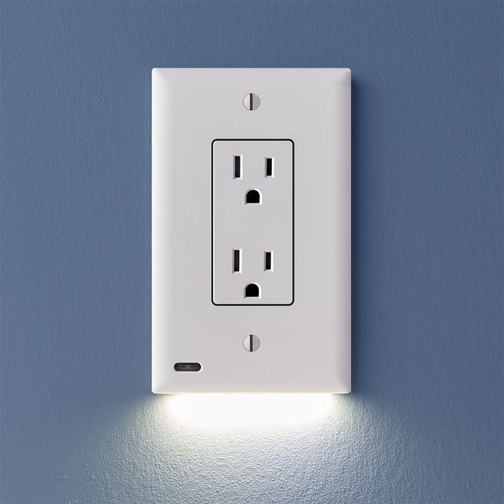 a white light switch on a blue wall with an outlet in the middle and two lights above it