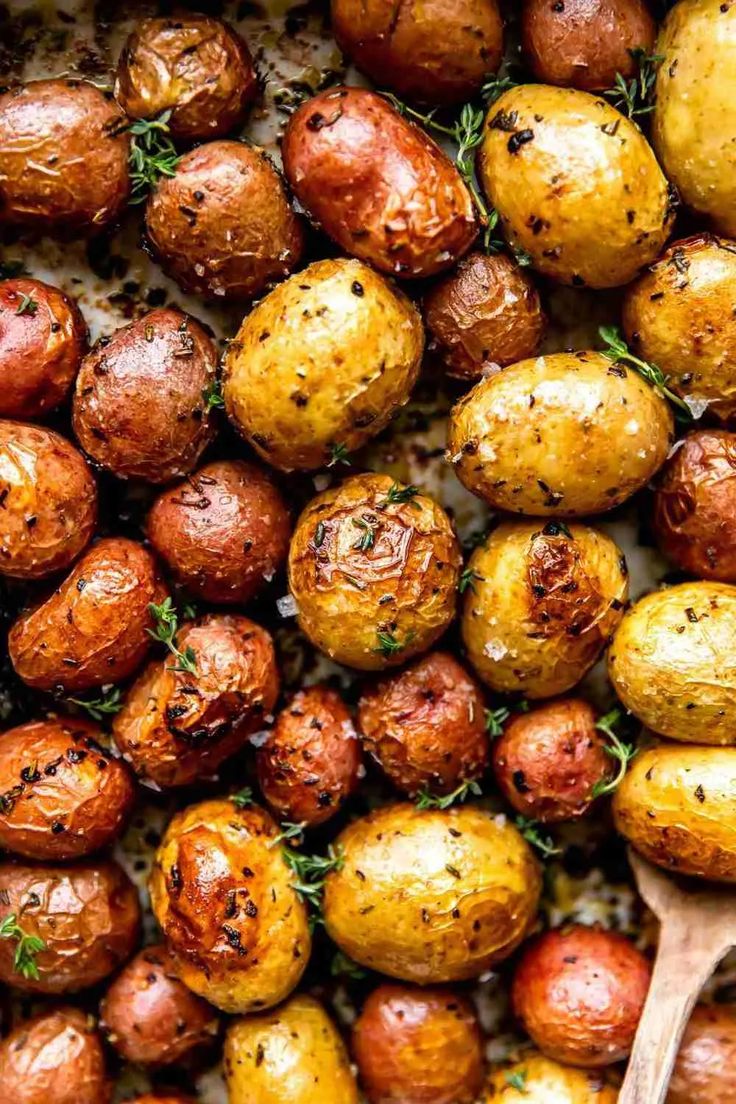 roasted potatoes with herbs and seasoning in a pan