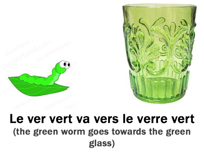 a green glass with a leaf in the shape of a caterpillar on it