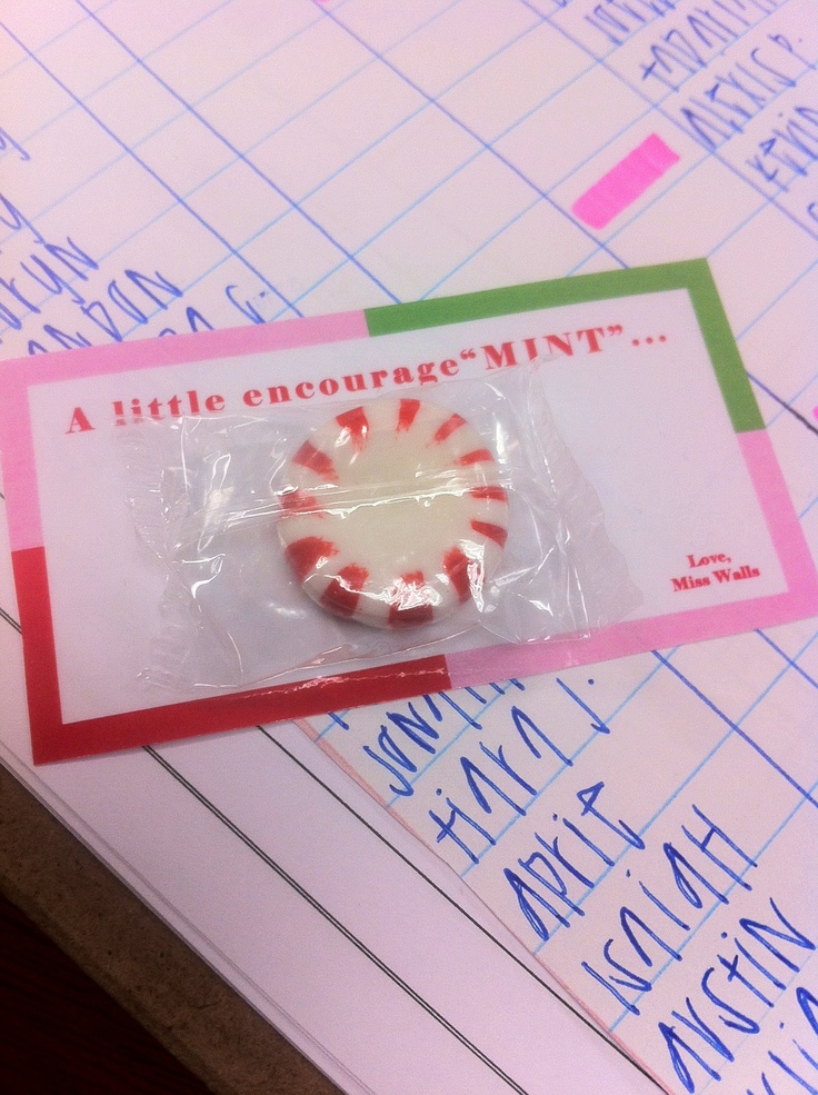 a candy cane in a plastic bag sitting on top of a piece of paper