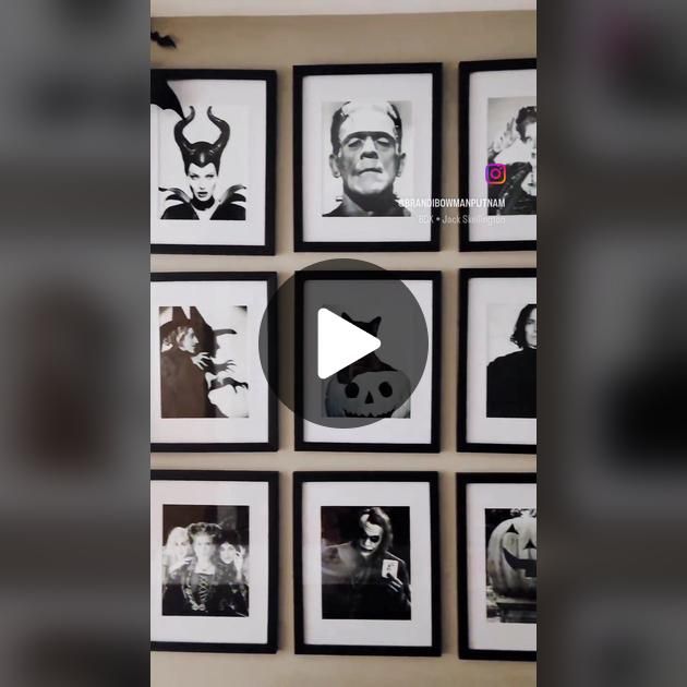 black and white photos are arranged on the wall with a video play button in front of them