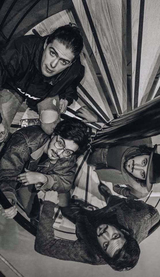 black and white photograph of four people standing together