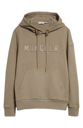 The label known for its impeccable outerwear adopts a more-lightweight approach with an all-cotton hoodie finished with a leather logo stitched to the chest. Drawstring hood Kangaroo pocket Ribbed cuffs and hem 100% cotton with leather contrast Dry clean Imported Designer Clothing Grenoble France, Apres Ski Style, Moncler Logo, Alpine Village, Luxury Outerwear, Tall Chest, Ski Fashion, Cozy Hoodie, Sleeping Bags