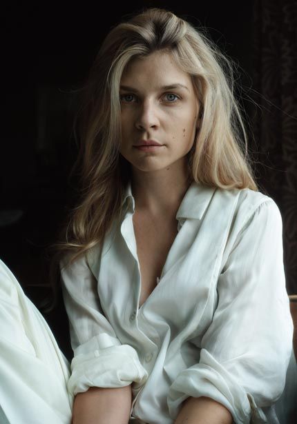 a woman sitting in a chair with her arms crossed