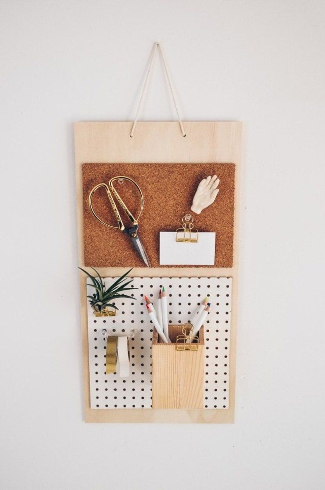 a cork bulletin board with office supplies on it