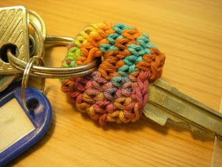 a multicolored crocheted keychain sitting on top of a wooden table