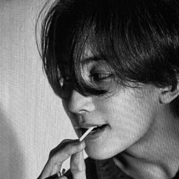 black and white photograph of a woman brushing her teeth