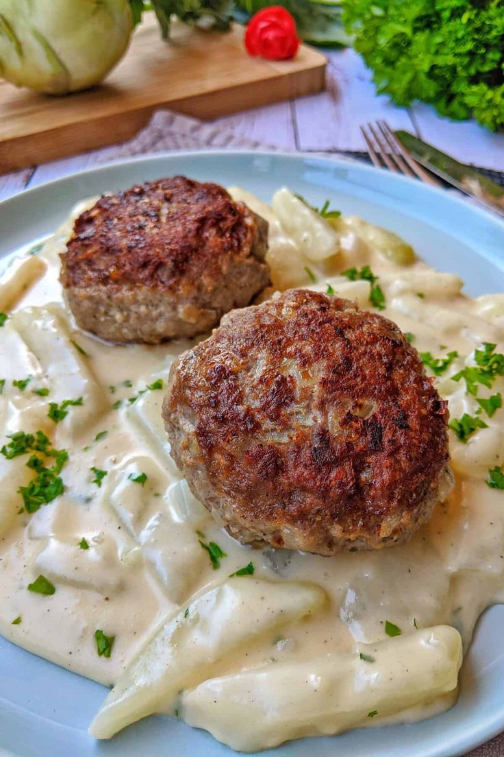 two meat patties with sauce on a plate