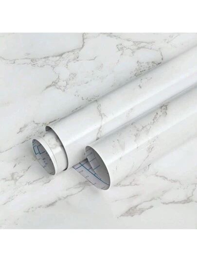 two white pipes laying on top of a marble counter