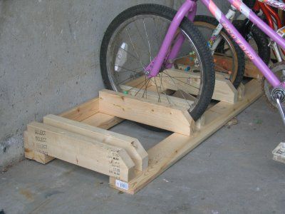 a purple bike is parked on a wooden platform