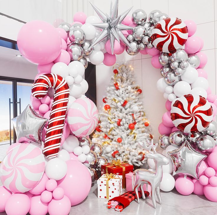 a christmas tree surrounded by balloons and decorations