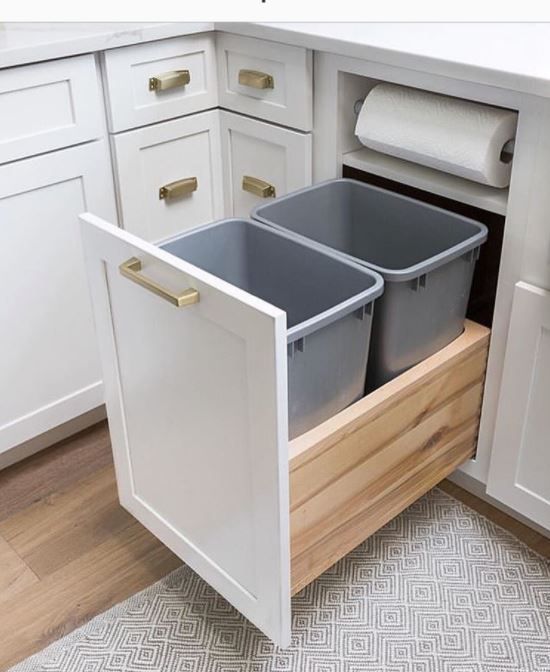 two bins in the middle of a kitchen cabinet