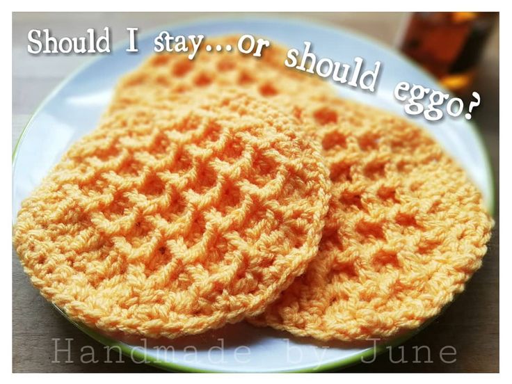 two crocheted coasters on a plate with the words should i stay or should egg?