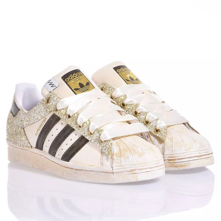 Adidas Superstar Bright Gold is the custom delicate and bold women's sneaker. Completely washed in gold with a gold and white glitter back and eyelets and cream-colored satin laces. &nbsp;Adidas Superstar Bright Gold will also come with its original white laces. Gold Sneakers With Speckled Midsole And Round Toe, Gold High-top Sneakers With Gum Sole, Gold Glitter Lace-up Sneakers, Gold Lace-up Sneakers, Gold Low-top Sneakers With Laces, Gold Low-top Sneakers With Glitter Accents, Gold Glitter Low-top Sneakers, Chloe Purses, Bright Gold