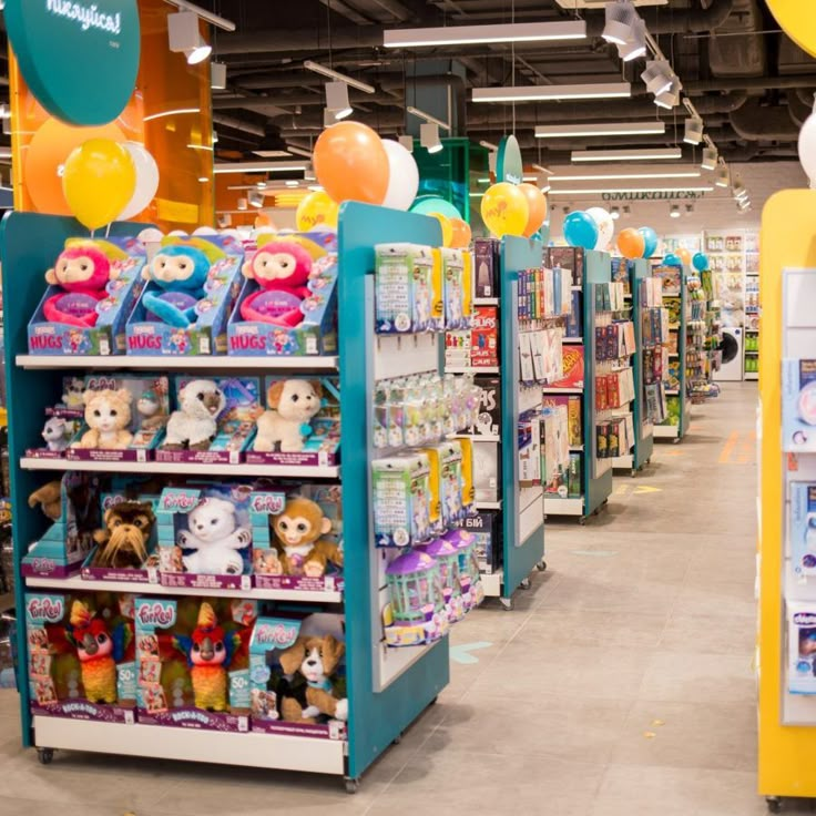 there are many stuffed animals on display in this toy store's aisles and shelves