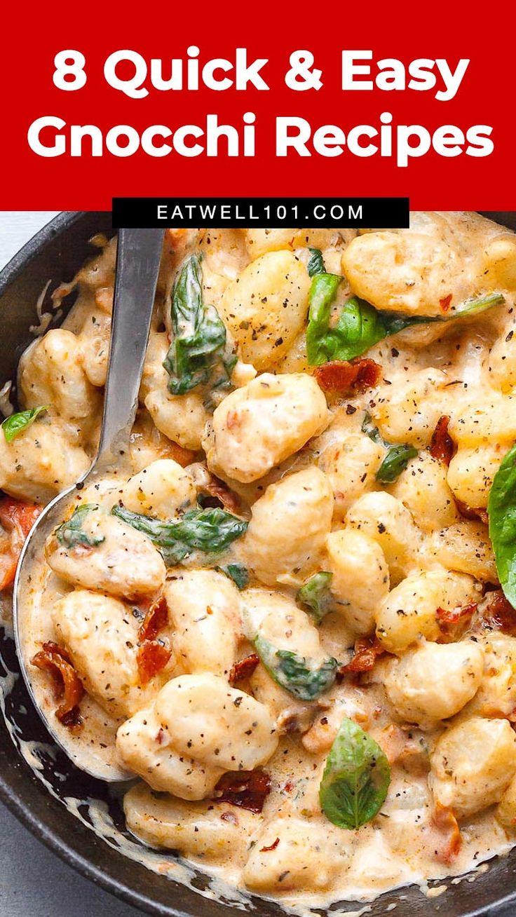 a skillet filled with gnocchini and spinach on top of a table