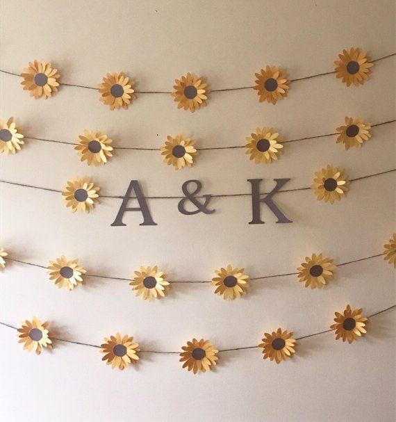 sunflowers are arranged on a string with the letters a and k