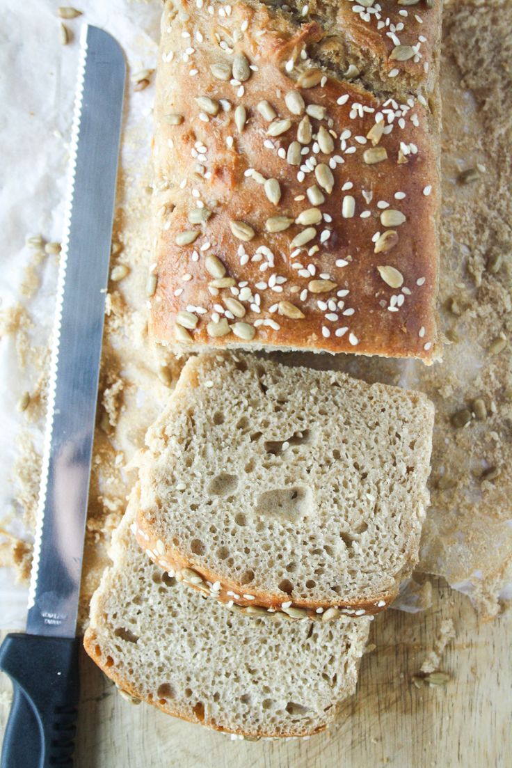 sliced loaf of bread sitting on top of a cutting board