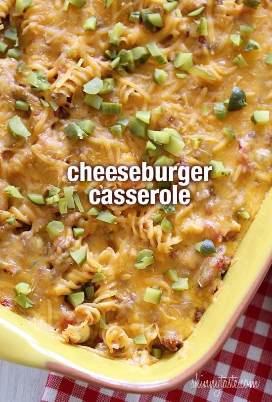 a casserole dish with cheeseburger and green onions in it on a checkered table cloth