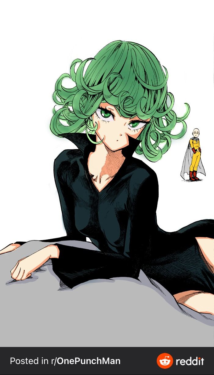 a woman with green hair sitting on top of a bed