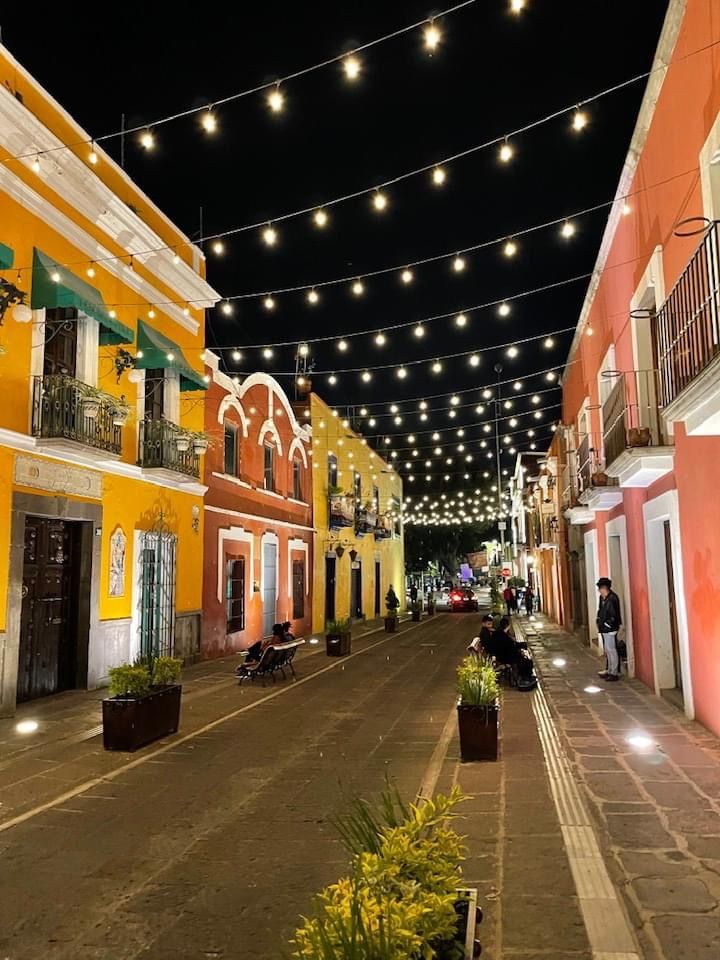 an empty street with lights strung over it