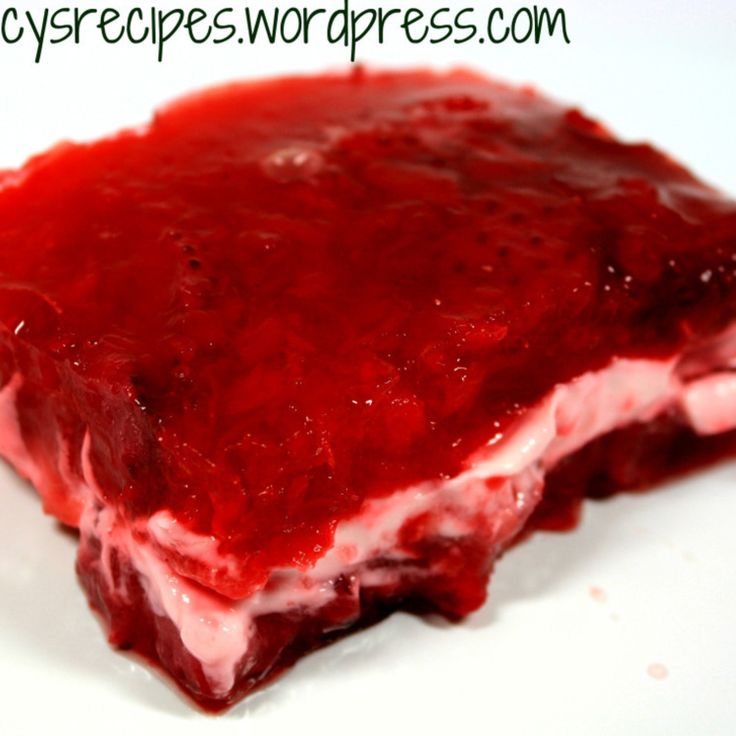 a piece of cake that is covered in red icing