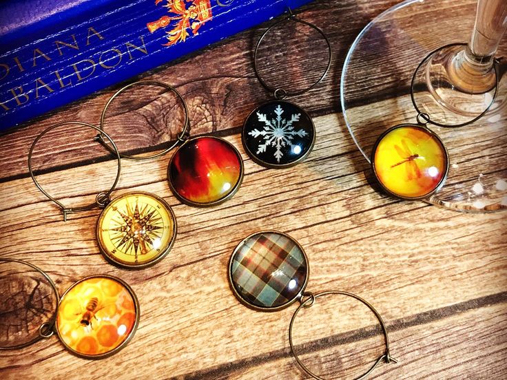 six wine glasses sitting on top of a wooden table