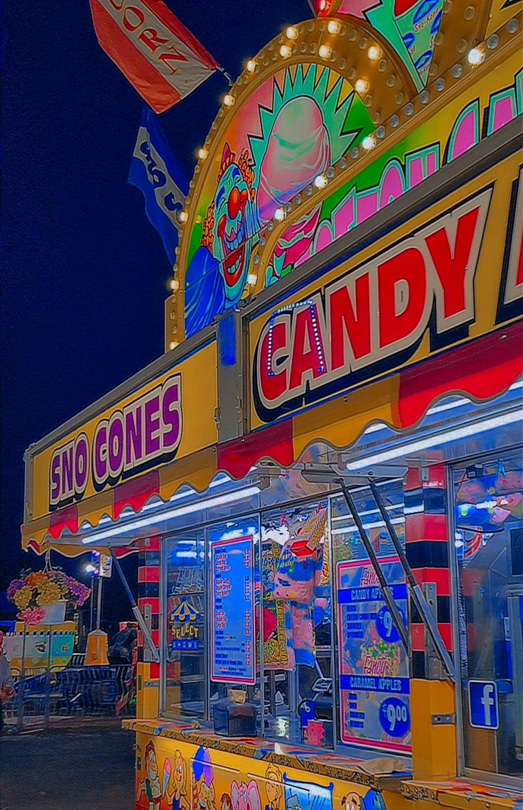 a candy land stand lit up at night