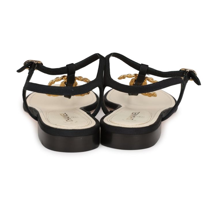 These Chanel Jeweled CC Thong Sandals are in Black Canvas with Gold Hardware. This sandal features a Gold Jeweled CC on the front of the sandal, an adjustable strap, natural leather insole, and rubber sole. Origin: ItalyCondition: New and never wornAccompanied by: Chanel box, dustbagsSize: 37 EU Elegant T-strap Sandals With Heel Strap For Beach, Elegant T-strap Sandals For Beach With Heel Strap, Elegant T-strap Sandals For Beach, Luxury T-strap Sandals For Beach, Designer Ankle Strap Sandals For Beach, Elegant Flat T-strap Sandals With Heel Strap, Flat Sandals With Buckle Closure For Evening, Elegant Sandals With Cushioned Footbed And Toe Post, Luxury Adjustable Open Toe Sandals