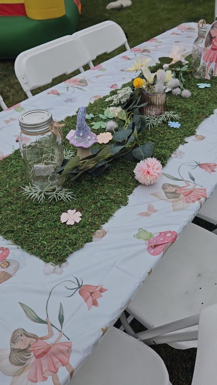 the table is covered with grass and flowers