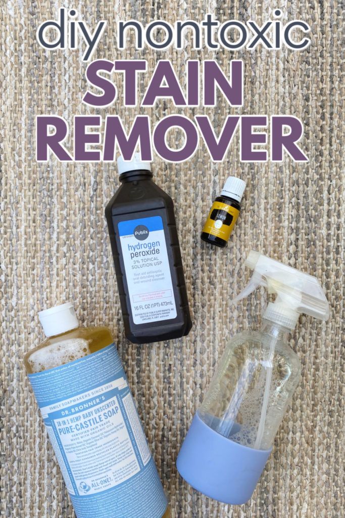 diy nontoxic stain remover and bottles on carpet with text overlay that reads diy nontoxic stain remover