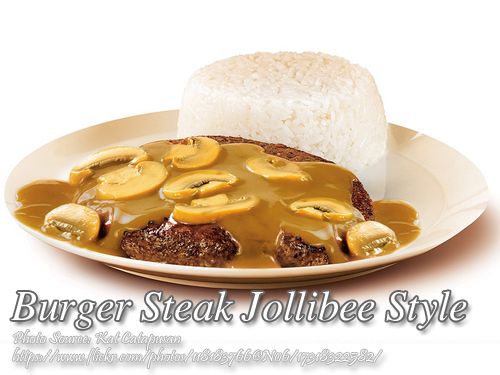 a white plate topped with meat covered in gravy and banana slices next to rice