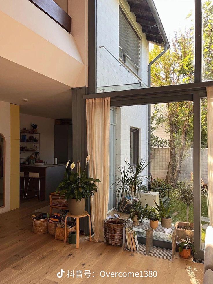 the inside of a house with wooden floors and large glass doors that lead to an outside patio