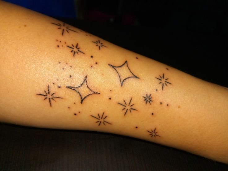 a person's arm with stars on it