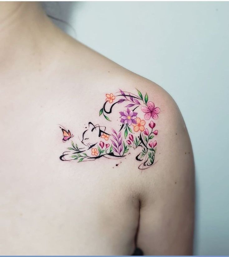 a woman's upper half with flowers and butterflies on her left shoulder, which has the letter e painted onto it