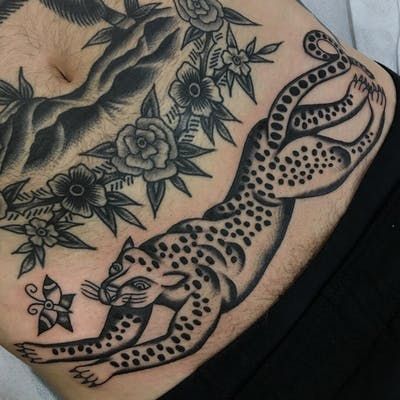 a man with a tattoo on his stomach has a cheetah and two leopards