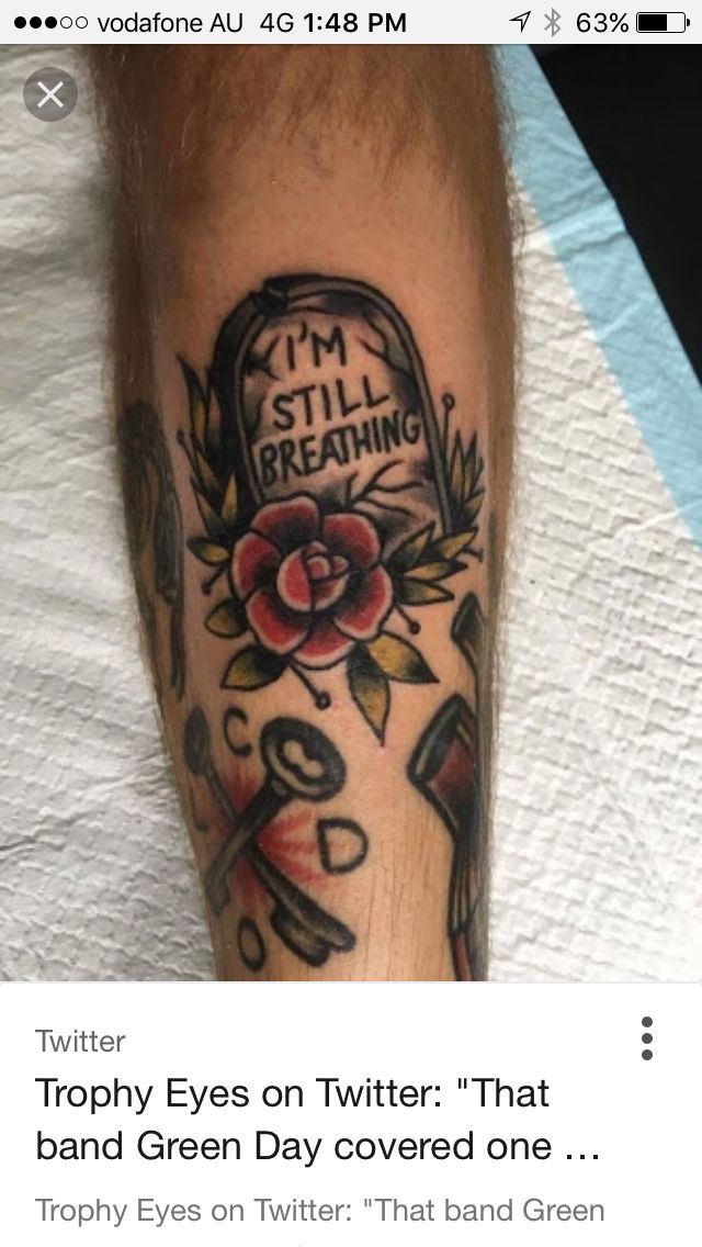 a tattoo with the words i'm still breathing on it and a rose in a basket