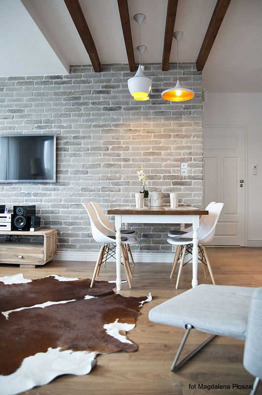 a living room filled with furniture and a flat screen tv on top of a wooden table