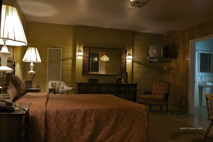 a bed sitting in a bedroom next to two lamps