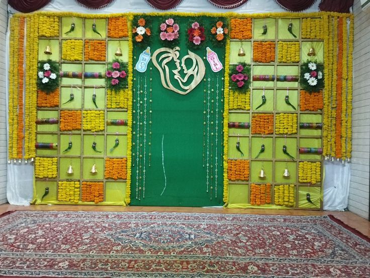 a green door decorated with flowers and decorations