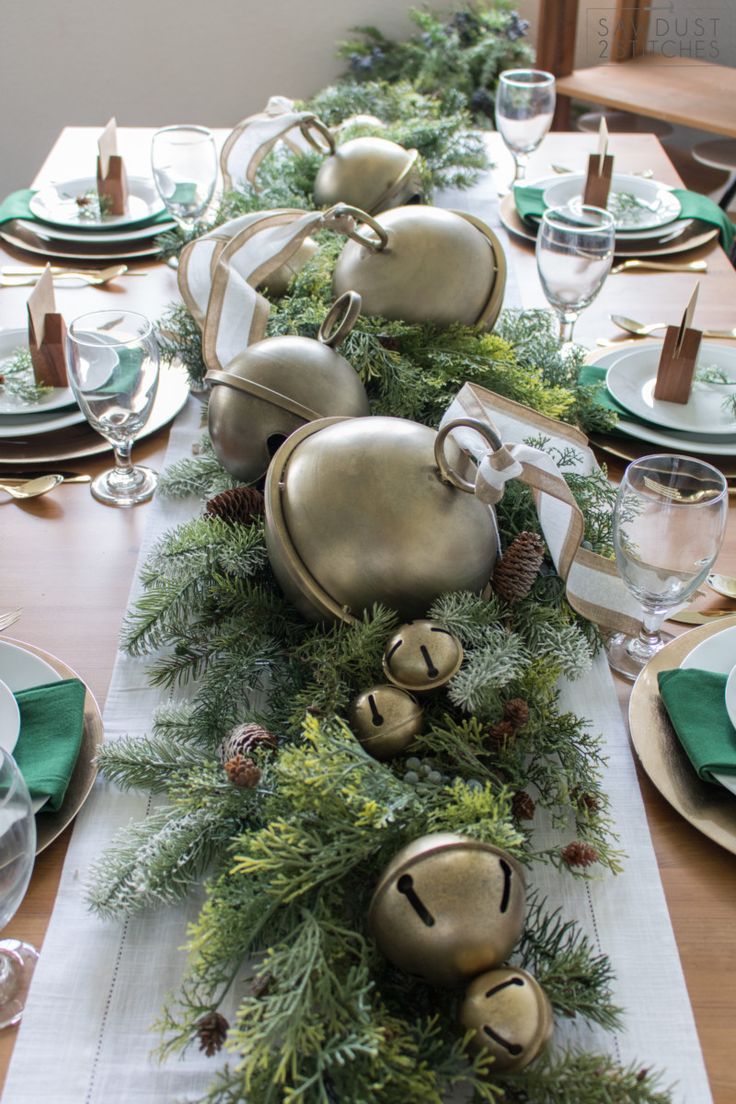 the table is set with silver and green decorations