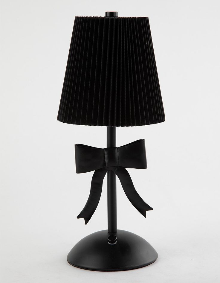 a black lamp with a bow on it